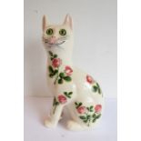 A large 'Griselda Hill Pottery - Wemyss' model of a seated cat; decorated with flowers and leaves