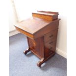 A late 19th century rosewood davenport desk; the stationery cabinet with hinged lid above a