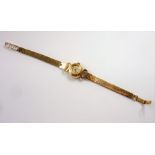 A ladies 9-carat yellow-gold-cased Omega 'Ladymatic' wristwatch; the signed dial with baton markers,