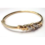 A 9-carat gold bangle set with small diamonds (approx. 8.59g) (The cost of UK postage via Royal Mail