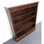 An early 20th century open oak bookcase raised on plinth base (91cm wide x 27cm (deepest at top) x