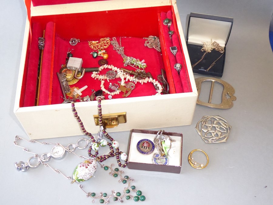 A jewellery box containing a wide variety of costume and silver jewellery to include necklaces,