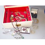 A jewellery box containing a wide variety of costume and silver jewellery to include necklaces,