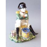 A novelty 19th century French pottery inkwell modelled as a seated Napoleon (18.5cm high)