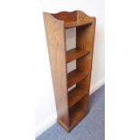 An early 20th century slim-proportioned oak open bookcase (31cm wide x 106cm high) together with a