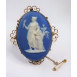 A boxed Wedgwood Jasperware brooch (The cost of UK postage via Royal Mail Special Delivery for