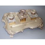 A 19th century silver-plated inkstand in high Rococo style, two cut-glass inkwells flanking a