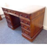 A 19th century mahogany pedestal desk; thumbnail-moulded top above an arrangement of nine drawers,