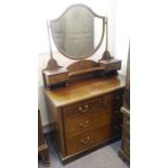 An Edwardian and mahogany chequer-strung dressing table; the shield-shaped mirror between two