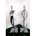 A pair of Art-Deco-style lamps of twisted nickel form (60cm high)