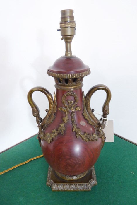 A 19th century rouge-marble gilt-metal-mounted table lamp (wired); the two handles unusually