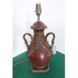A 19th century rouge-marble gilt-metal-mounted table lamp (wired); the two handles unusually