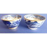 Two 19th century blue-and-white tea bowls; both decorated in the Chinese taste and with gilded