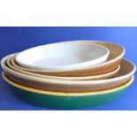 A selection of five graduated oval stoneware kitchen dishes