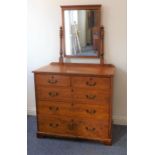 A late 19th century pitch-pine dressing chest; the rectangular mirror above an arrangement of two