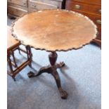 An 18th century-style (probably early 20th century) tilt-top mahogany wine table; the pie-crust edge