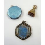 A circular white-metal and blue-enamel photo locket together with an hexagonal white-metal and