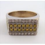 A 9-carat gold ring set with 38 yellow diamonds and 50 white brilliant-cut diamonds; ring size U/