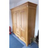 A large and heavy solid oak triple wardrobe (modern); the left-hand panelled door enclosing