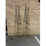 Two black garden obelisks; each with open wrythen finial