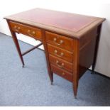 A late 19th/early 20th century mahogany and satinwood cross-banded desk; the gilt-tooled, red-