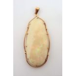 A very fine 18-carat gold-mounted 60-carat opal pendant (total weight 23.38g) (The cost of UK