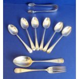A set of six hallmarked silver teaspoons with bright-cut engraving, one further larger teaspoon, a