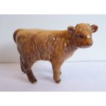 A Beswick porcelain model of a Highland calf (7cm high)