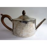 A George III period hallmarked silver oval teapot; monogrammed and with a bright-cut border