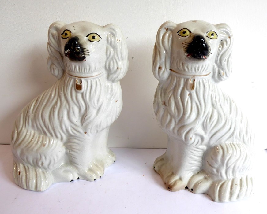 A pair of 19th century Staffordshire spaniels (25cm high)