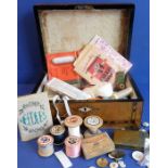 A mid-19th century walnut and banded sewing box with a variety of sewing and other items within