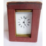 An early 20th century brass and glass-sided carriage clock within original hard travel case (the