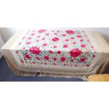 A needlework bed cover; finely embroidered with flowers, leaves and tendrils, long tasselled lace