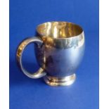 A heavy hallmarked silver christening tankard; assayed London 1937 with a named inscription and