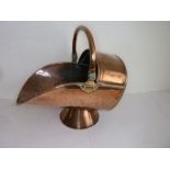 A 19th century helmet-shaped copper coal scuttle