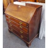 A late 18th century mahogany writing bureau; the angular cleated fall opening to reveal fitted