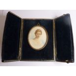 An early 20th century shoulder-length miniature of a lady in its leather case