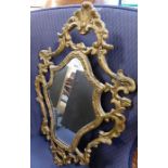 A Rococo-style gilt wood wall-hanging looking glass
