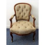A mid-19th century walnut spoon-back open armchair with carved arms, button-down seat and moulded
