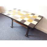 An original 1950s/60s tile-topped coffee table on wrought-iron supports, (101cm wide x 51cm deep)