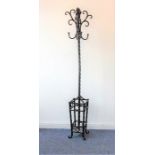 A modern ironwork effect hat and coat stand having wrythen stem and base for umbrellas