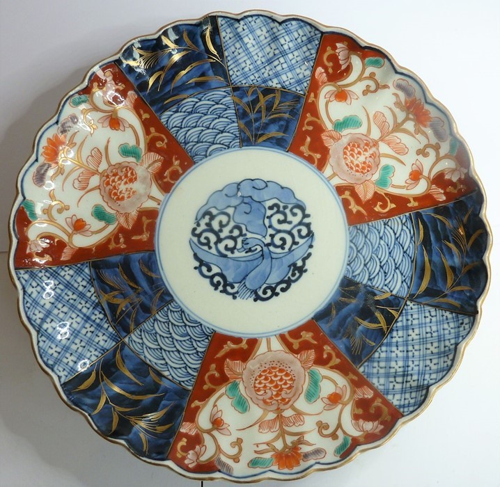 A 19th century Japanese porcelain dish, hand-gilded and decorated in the Imari palette, four-