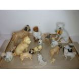Sixteen, mostly small, decorative ceramic pug dogs and bulldogs to include a 19th century 'basket'
