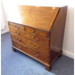 A late 18th century mahogany writing bureau; the angular-cleated fall opening to reveal fitted