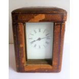 A late 19th / early 20th century brass carriage clock; white enamel dial with Roman numerals,