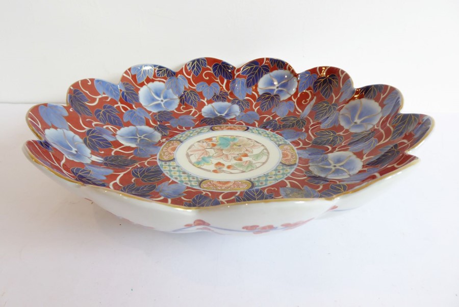 A Japanese flower-head shaped porcelain dish hand-gilded and decorated in the Imari palette, three-