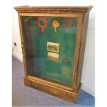 A freestanding early/mid-20th century stained wood display cabinet, single glazed door enclosing a