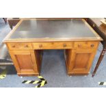 A 19th century mahogany pedestal desk; the leather inset thumbnail moulded top above an