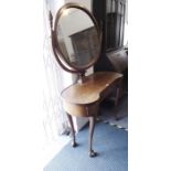 An early 20th century kidney-shaped mahogany dressing table; the oval mirror above a single