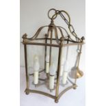 A large six-lamp hexagonal brass and concave glass-sided ceiling hanging lantern